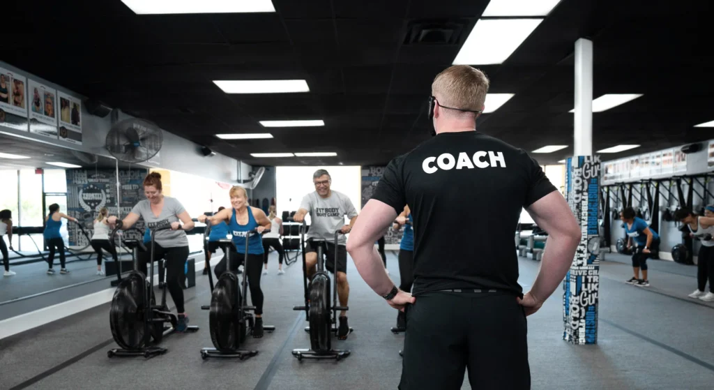 Fitness coach teaching an exercise class at Fit Body Boot Camp