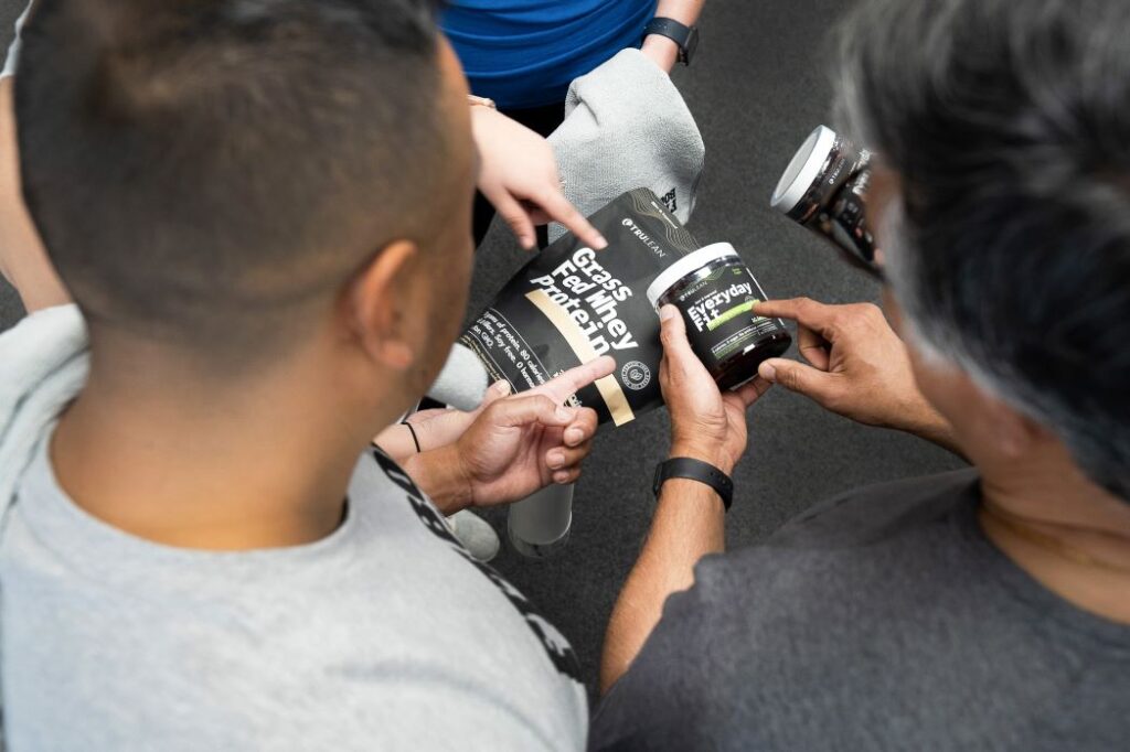 Men looking at protein powder at Fit Body Boot Camp