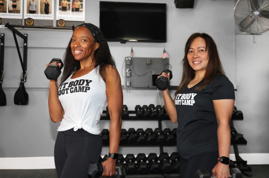 Two women working out with dumbells