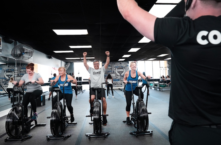 group of people performing cycling work outs