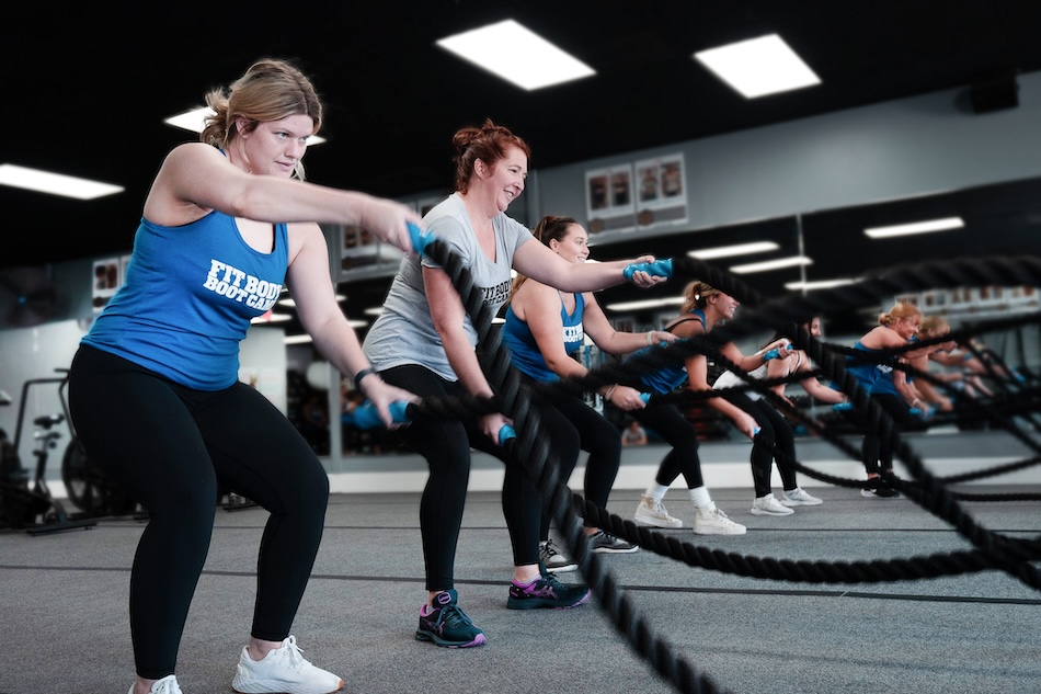 women performing group rope exercises