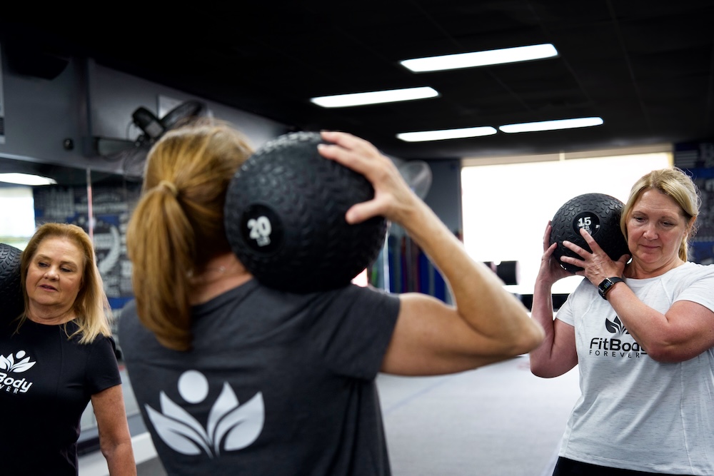 Group of people working out with weighted ball.