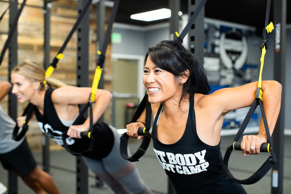 People working on pushing muscles during group fitness.