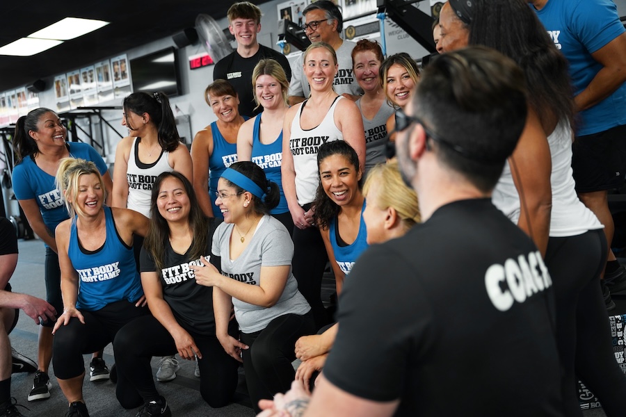 Fitness group smiling and posing after bootcamp workout