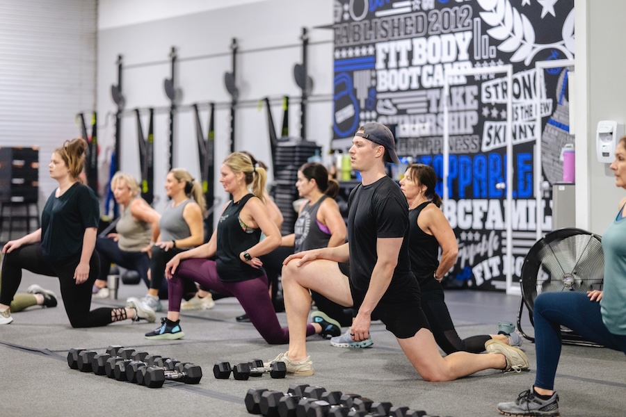 Group stretching session during a Fit Body Boot Camp workout.