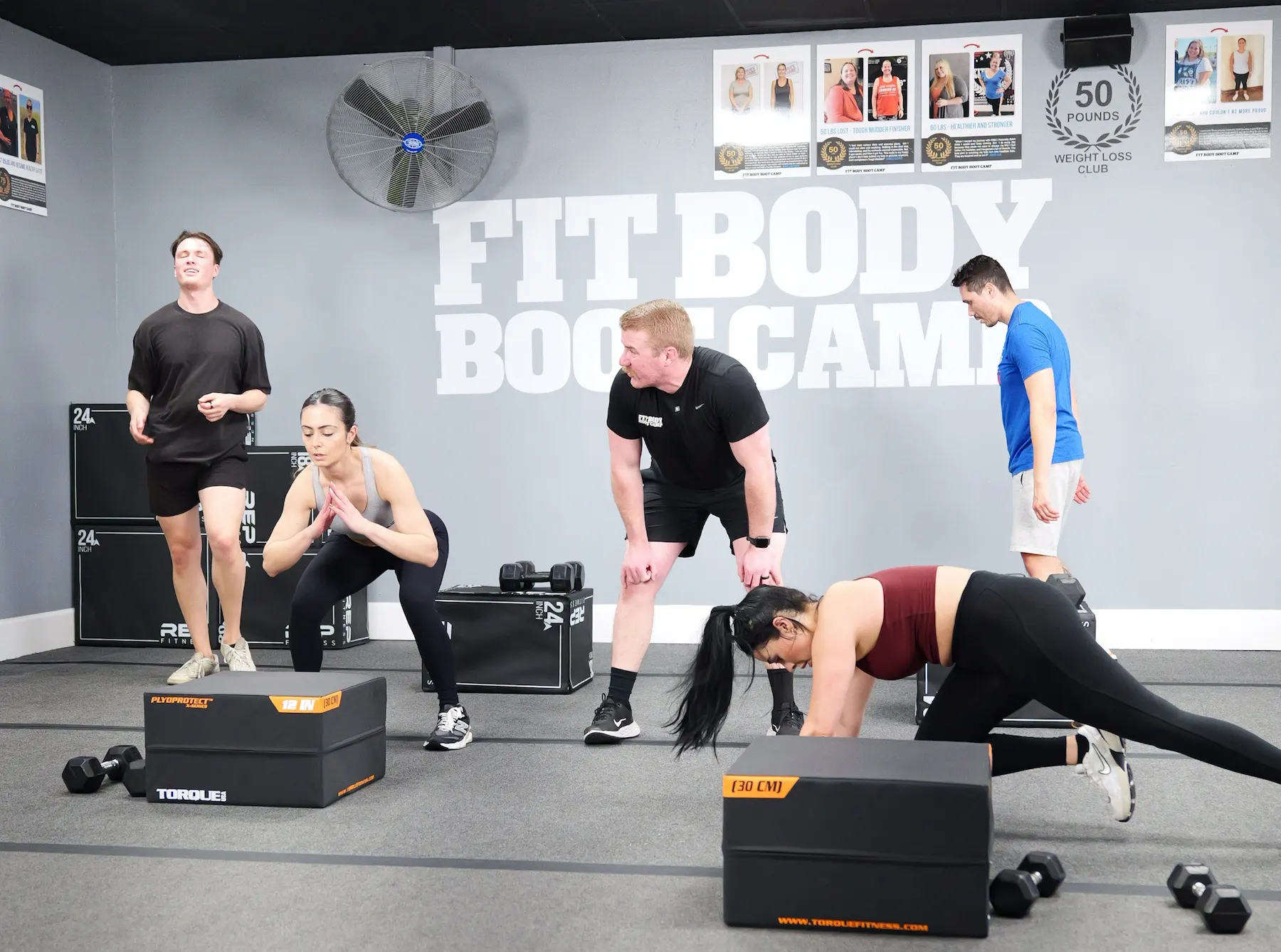 Fit Body Boot Camp fitness coach leading a group workout session.