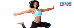 Woman in black and blue work out clothes jumping in the air