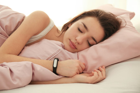 woman sleeps soundly to maintain her health and stay on track after working out